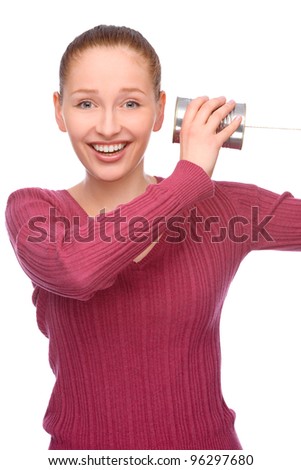 Full isolated studio picture from a young and happy woman with tin phone