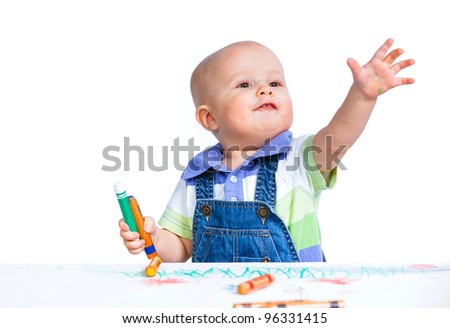 Portrait clouse-up of little sweet boy draws with crayons in red, isolated on white