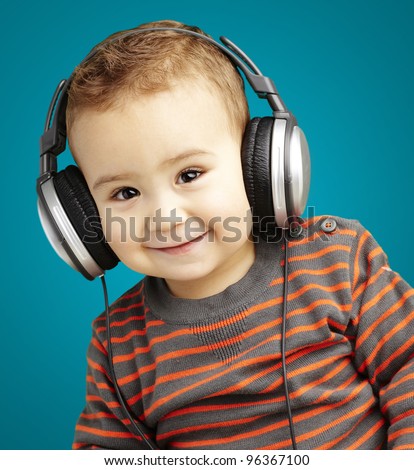 portrait of a handsome kid listening to music and smiling over b