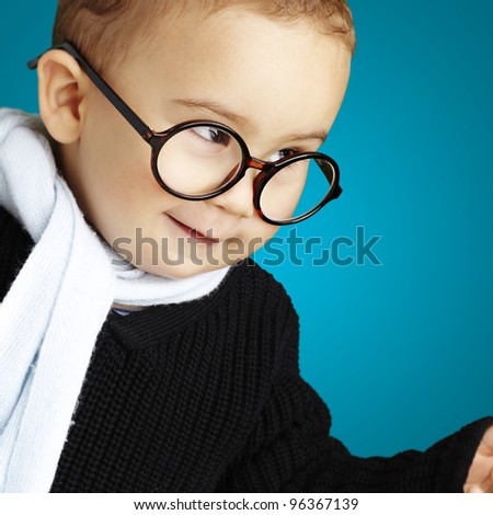 portrait of adorable kid gesturing doubt against a blue background