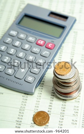 Calculator and Coins On Financial Paper