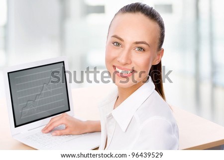 Portrait of smiling business woman working with laptop