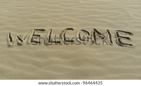 Welcome concept with sign on the sea shore.