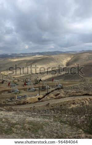 A cluster of pumping units (oil wells) located in the foothills of the Sierra Nevada, California