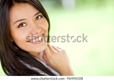 Portrait of a beautiful Latin woman smiling - outdoors