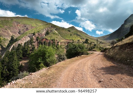 dirt road to the top of mountain Kaliakouda in Evritania, Greece Royalty-Free Stock Photo #96498257