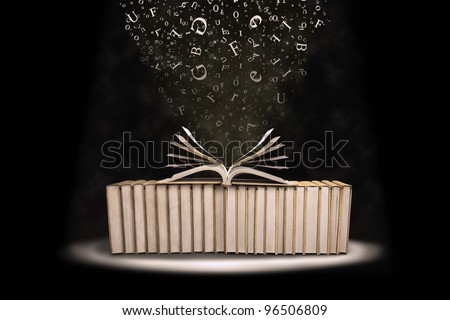 Stack of books with flying letters shot in studio