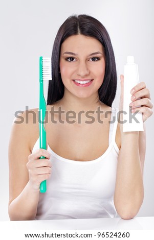 Young woman with Equipment for Oral Hygiene toothbrushes and  toothpaste