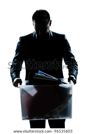 one caucasian man portrait silhouette carrying heavy box in studio isolated white background