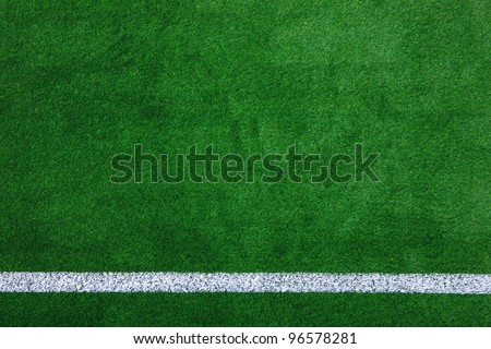 Photo of a green synthetic grass sports field with white line shot from above. Royalty-Free Stock Photo #96578281