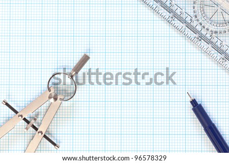 Still life photo of engineering graph paper with a fine 0.1mm pen, compass and protractor ruler, blank to add your own design, image or text.