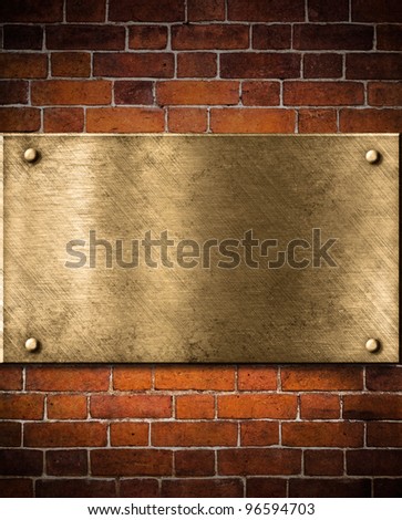 old golden or bronze plate on brick wall