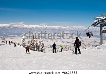 Rope-way lifting skiers to mountain-skiing lines on mountain Todarko, a resort of Bansko, Bulgaria Royalty-Free Stock Photo #96621355
