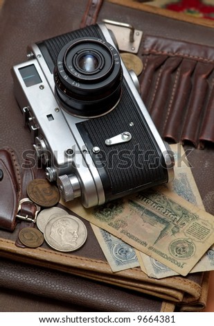 Old soviet film camera and money vertical close up