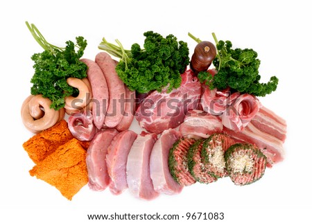 Variety of pork and beef meat on white surface,  studio shot, garnished with pepper mill and  parsley