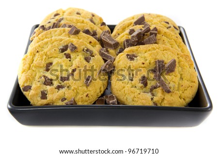 A picture of two stacks of some chocolate cookies with some chocolate on a black plate