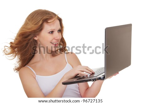 Beautiful happy girl with flowing hair holding a laptop isolated on white background