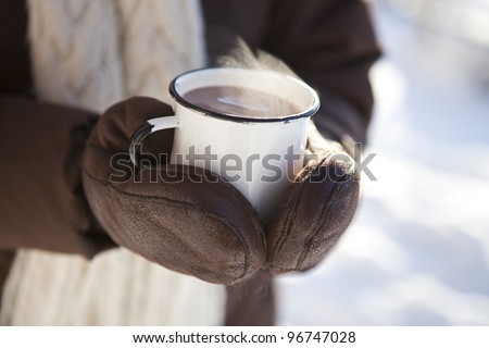 Mug of hot chocolate outdoors on a winter day