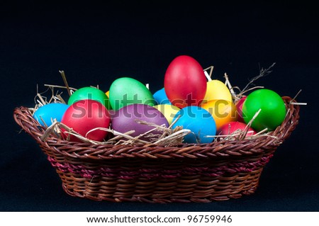 Easter eggs in  brown pannier on a black background