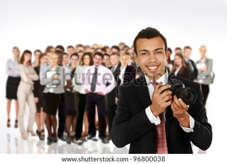 A smiling professional photographer and group people