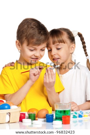 Two children painting Easter eggs isolated on white background