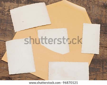 vintage background with old photo and yellow envelope on old wood background