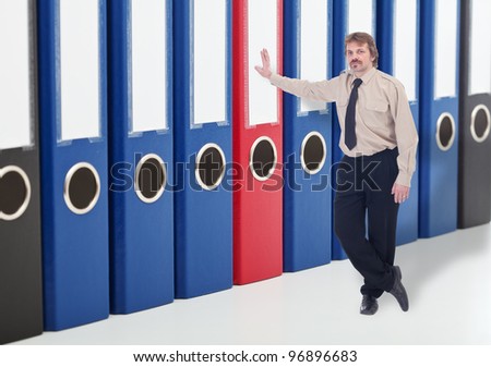 Man leaning against business archive folders - keeping data safe concept