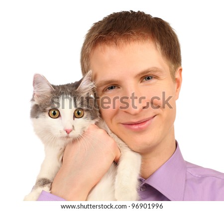 Smiling young man holds surprised cat isolated on white background