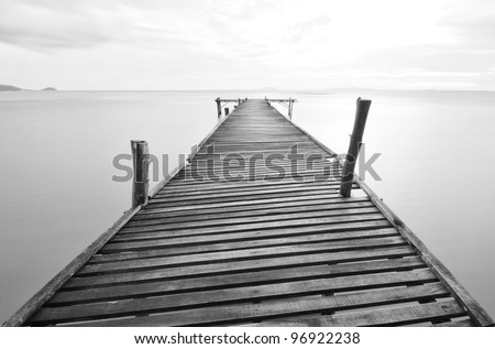 black and white picture of old bridge to the sea.