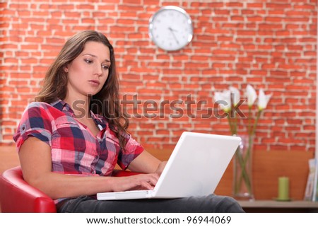 Woman using laptop in restaurant Royalty-Free Stock Photo #96944069