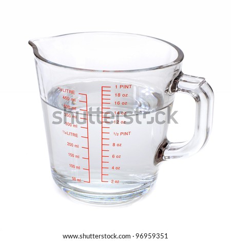 Water in measuring cup isolated on white background Royalty-Free Stock Photo #96959351
