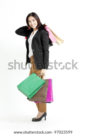 Business woman holding shopping bags against a white background