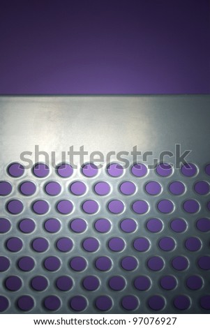 Photo of an iron grate on purple background