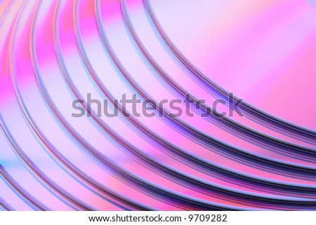 Abstract purple CD background. Closeup of stacked CDs or DVDs.