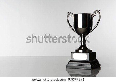 still life image of a single trophy standing in a white background Royalty-Free Stock Photo #97099391