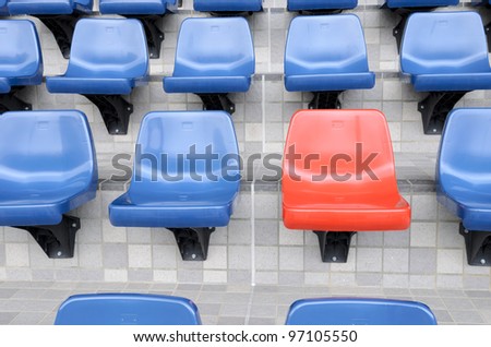 Plastic red and blue new chairs in stadium