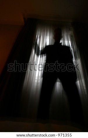 man shot against the light of a window  (slow shutter speed, the man been on the picture for only part of the exposure and therefore a bit transparent)