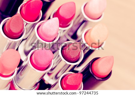 cosmetics: lipsticks shot at shallow depth of field Royalty-Free Stock Photo #97244735
