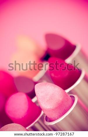 cosmetics: lipsticks shot at shallow depth of field Royalty-Free Stock Photo #97287167