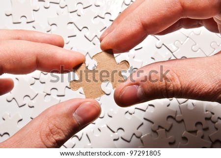 two hands holding puzzle piece