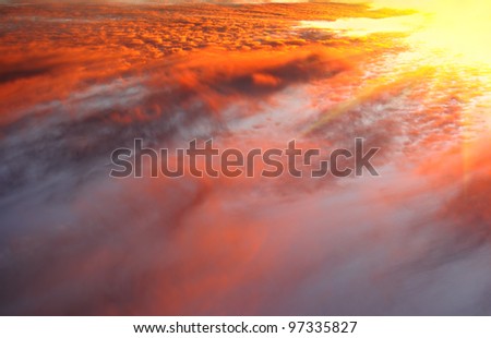 Dramatic sky with storm clouds against sunrise. Summer background.