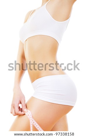 sporty woman figure with tapemeasure on leg on white background