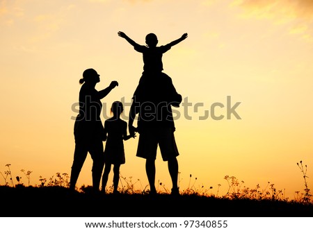 Happy family in nature at sunset