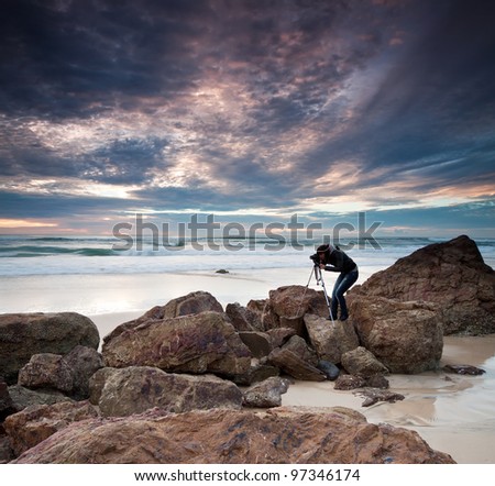 woman photographer takes photo of the beautiful seascape (miami beach, queensland, australia)