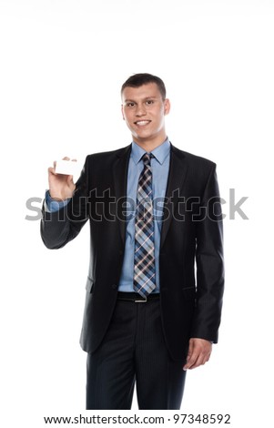 Portrait of a businessman in a business suit with a white business card in his hand