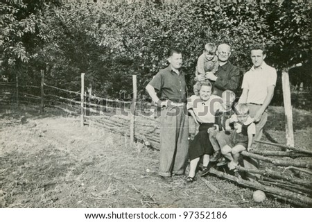 Vintage photo of happy family outdoor (sixties)