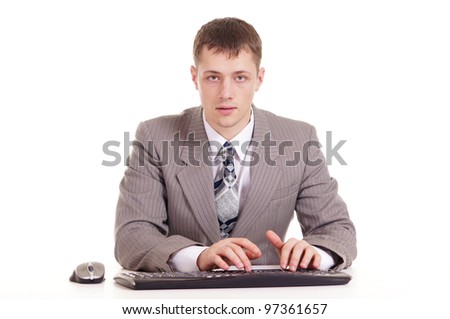 businessman in a suit sitting at a laptop on a background