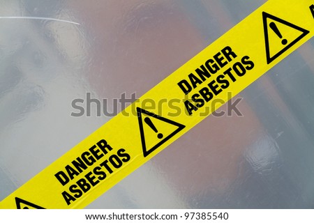 Danger Asbestos yellow warning tape close up