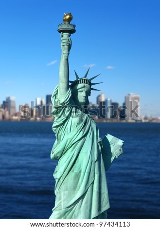 New York: The Statue of Liberty, an American symbol, with Lower Manhattan skyline in the background. Tourism concept photo. Liberty Island, New York City, USA