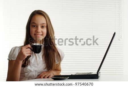 nice woman at the computer sits on a white